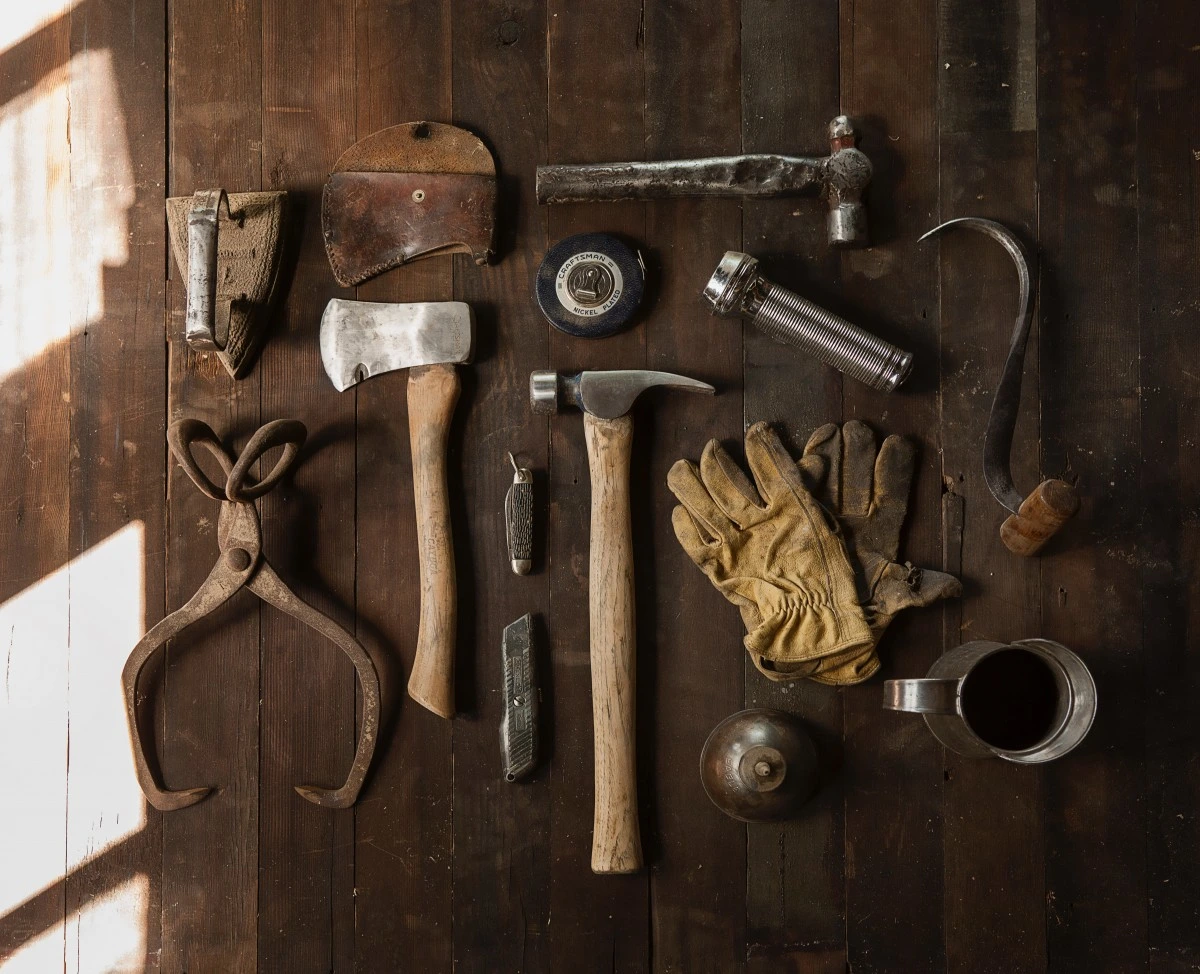 Collection of antique Stanley planes, vintage Disston saws, and rare hand tools displayed for identification